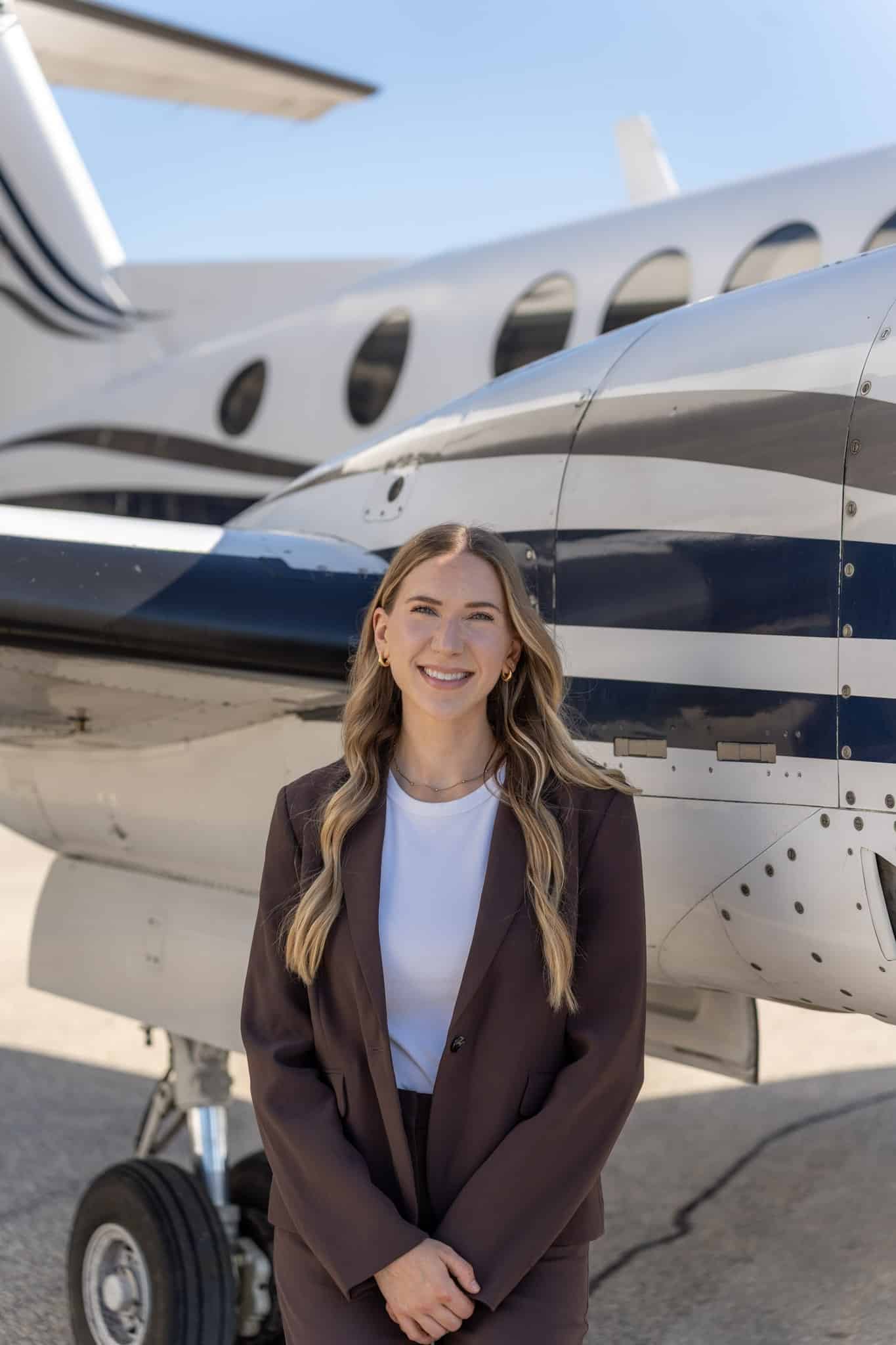 Woman standing beside airplane